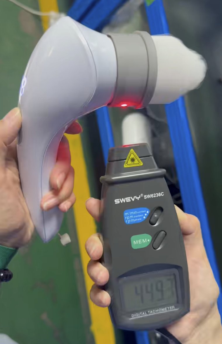Measuring a product's output with a tachometer during a factory check