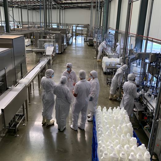 A packaging line running bottled product in a manufacturing facility
